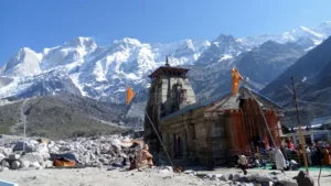 Ancient Kedarnath Temple with snow-covered Himalayan peaks in the background.