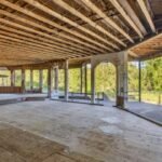 In 1994, Hollywood Video’s founder bought 32 Oregon acres for $1.25 million and began a 52,000-sq-ft mansion; nearly 30 years and 3 owners later, it is still unfinished and asking $4.7 million