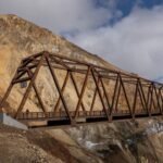 In 2021, a landslide cut Denali National Park’s only road in two; five years later a $230 million, 475-foot bridge has been built directly above the still-moving slope