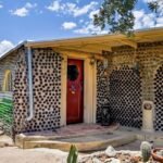 In 1964, an Arizona couple began building a carport with discarded bottles; years later, the project had grown into a 2,700-sq-ft home made with thousands of bottles and listed for $432,500