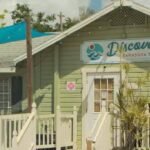 Florida couple’s colorful Sarasota cottage village houses 17 small businesses; a 324-apartment plan threatened demolition, but owners canceled the sale and took the property off market