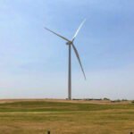 On a 160-acre Nebraska farm parcel, one wind turbine and its equipment use about 1 acre; the developer says a typical 30-year lease averages $10,000 to $12,500 a year, versus about $600 for top-dollar corn on that acre
