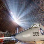 An 83-year-old Oregon blimp hangar was sold for $1 after a storm tore a 200-foot hole in its roof; after nearly 10 months shut, the air museum inside is now set to reopen on October 29