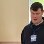 A blind UK man applied for more than 1,000 jobs without success and spent 16 months unemployed, then built an accessibility business; at 23, Brandon Hulcoop has won the King’s Trust Young Achiever award